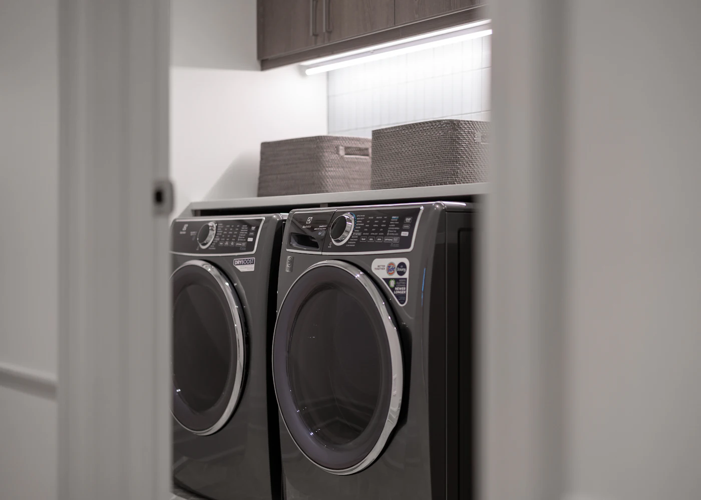 Modern front load washer and dryer set in a laundry room